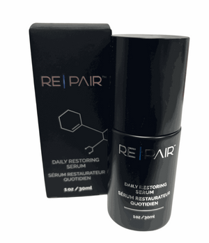 EXOIE REPAIR Daily Restoring Serum in sleek black 30ml bottle and matching box with minimalist white and blue text design.