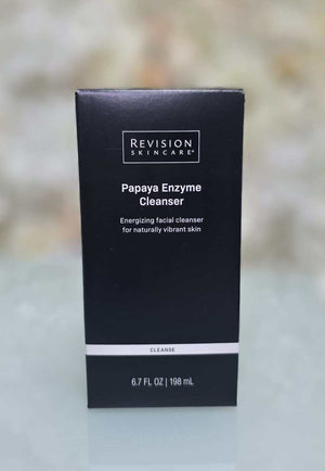 Revision Skincare Papaya Enzyme Cleanser black rectangular box with white text and minimalist design for facial cleansing product packaging.