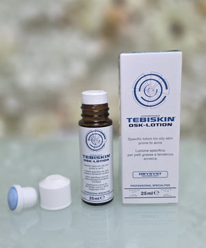 Tebiskin OSK-Lotion 25ml brown glass bottle with white cap and white packaging box featuring blue and black text and circular design logo