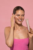 Airyday Night Rain Sleep Mask in a pale pink tube, shown with white cream applied to the cheek.