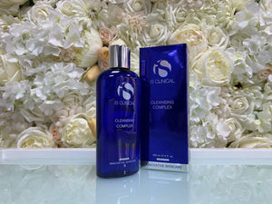iS Clinical Cleansing Complex in a blue plastic bottle with silver cap alongside matching blue box featuring white text and logo.