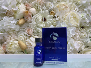 iS Clinical Hydra-Cool Serum in a blue glass bottle with black cap and matching blue box packaging, sleek and modern design.