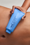 VOL.U.LIFT BODY GLP-1 Sculpt + Firm Treatment Complex held against abdomen for body skin firming