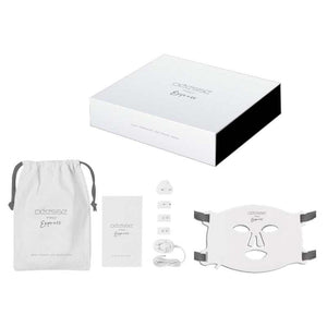 Déesse Pro LED Mask white flexible silicone light therapy mask with USB charger, power adaptors, head straps, eyewear, and pouch.
